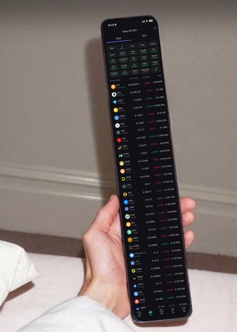 A hand holds a smartphone displaying a cryptocurrency tracking app showing various tokens with their prices and percentage changes, likely being reviewed to identify noteworthy new projects worth paying attention to.