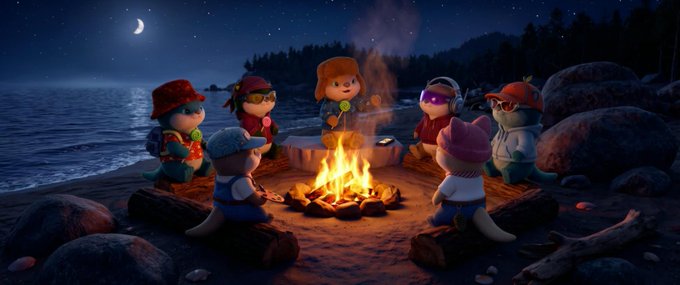 A whimsical 3D-rendered nighttime scene depicts a group of cute cartoon animal and human characters gathered around a glowing campfire on a rocky lakeshore, with a crescent moon and stars in the dark blue sky above.