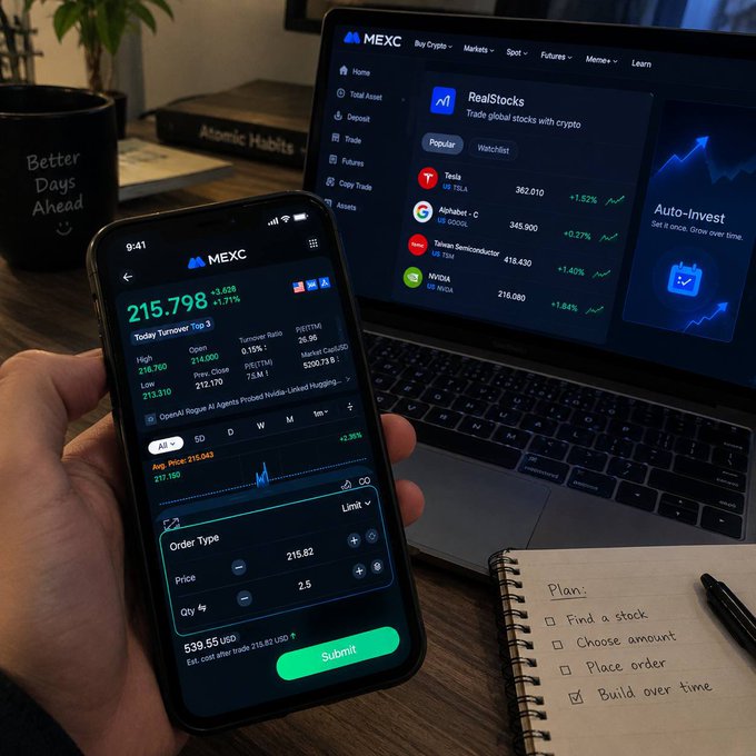 A person's hand holding a smartphone displaying the MEXC crypto trading app showing a stock price of 215.798, with a laptop in the background also showing MEXC's RealStocks feature and a notebook listing a plan: 'Find a stock, Choose amount, Place order, Build over time'.