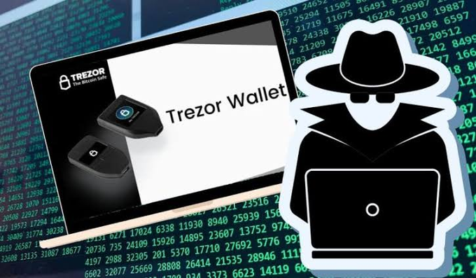 A 'Trezor Wallet' hardware crypto wallet displayed on a tablet, paired with a cartoon hacker illustration in a black hat and trench coat working on a laptop against a background of green code.