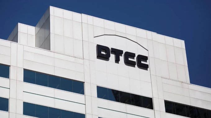 The exterior of a white building displays a 'BTCC' logo against a clear blue sky.
