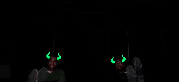Two people in a dark room are shown wearing green digital horn filters, with angel wings visible on their backs, visually reinforcing the post's playful comparison of $ANSEM as the "Yeezy of Crypto."