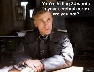 The image shows a man in a dark uniform sitting at a desk with his hands folded, with overlaid text reading "You're hiding 24 words in your cerebral cortex are you not?"