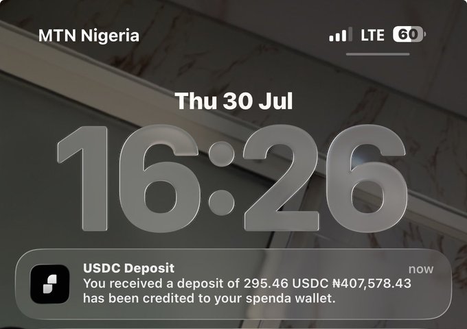 A phone lock screen on MTN Nigeria showing 16:26 on Thu 30 Jul, with a USDC Deposit notification from Spenda confirming 295.46 USDC (₦407,578.43) has been credited to the user's wallet—illustrating the successful crypto deposit the poster is celebrating.