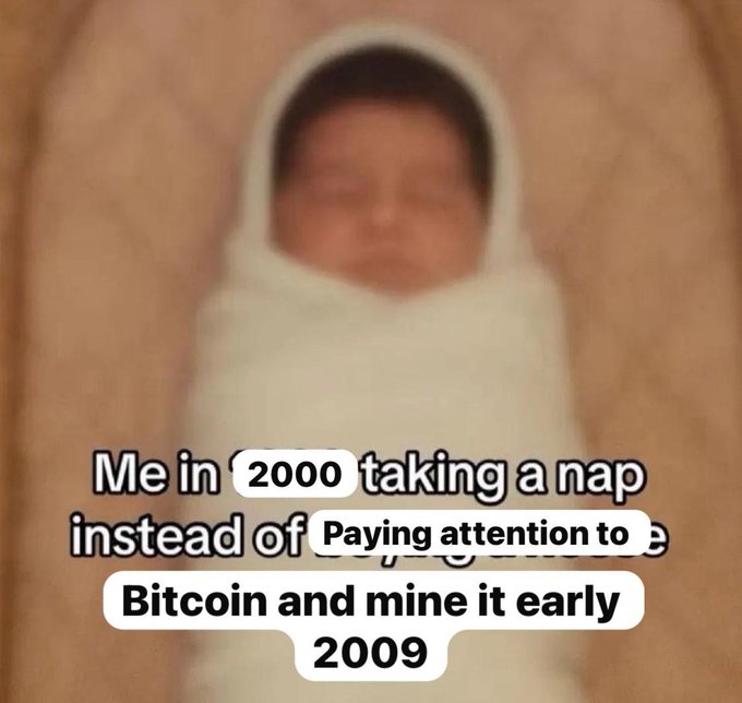 A blurry meme image of a swaddled baby with text: 'Me in 2000 taking a nap instead of [paying attention to] Bitcoin and mine it early 2009'.