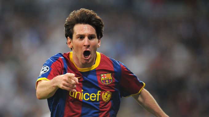 Lionel Messi in a Barcelona jersey with 'unicef' sponsorship, celebrating passionately during a UEFA Champions League match.