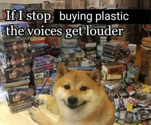 A Cheems dog meme sitting amid stacks of model kits with the text 'If I stop buying plastic the voices get louder.'