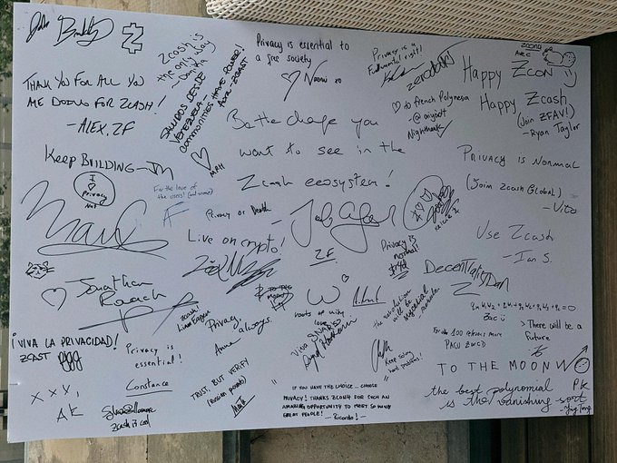 A photograph of a white board or paper covered in handwritten signatures and messages from various people, with visible phrases including 'Zcash', 'Privacy is essential to a free society', 'Happy Zcon', 'Keep Building', and 'VIVA LA PRIVACIDAD'.