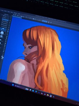A laptop screen displays a digital painting in progress of a woman with flowing orange hair against a blue background, shown within what appears to be a Photoshop or Procreate interface. The artist's caption suggests this is a final "work in progress" shot of a meme card submission for the 6529 project.