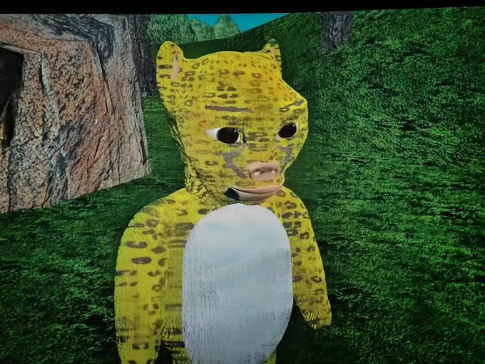 A low-poly 3D rendering of a yellow spotted big cat character stands in a grassy virtual environment, exemplifying the simplistic, amateurish NFT artwork style that fetched over $10,000 USD during the 2021 crypto art boom.