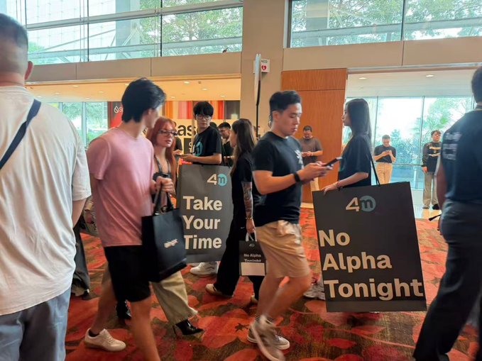 Two people carry signs reading "4m Take Your Time" and "4m No Alpha Tonight" through a crowded event hall, promoting 4M Exchange in Singapore. The signs and context suggest 4M Exchange is hosting an Alpha Night event, which the accompanying post criticizes as a disappointing exchange experience.