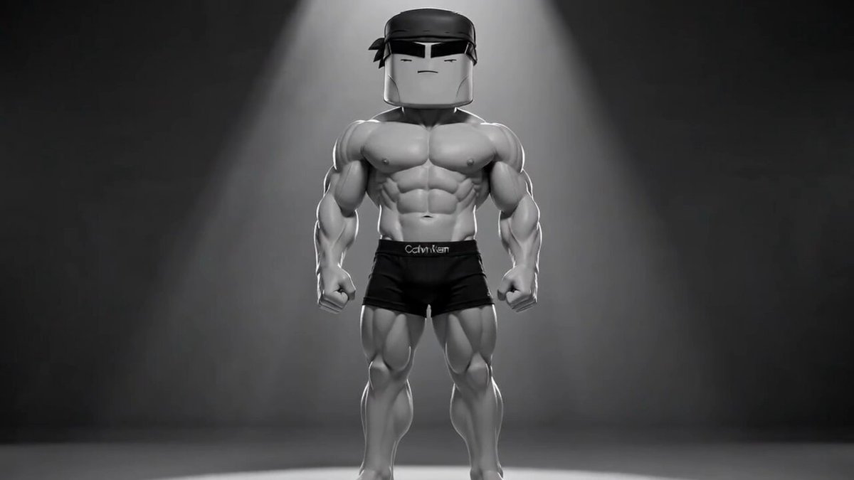 The image features a muscular man wearing black shorts standing against a dark background with a spotlight shining directly on him. The caption below the image reads "$MOG stands for Mentality of GOATS. The mindset of winning, dominating, and striving to be number one." This suggests that the image is related to bodybuilding or fitness, possibly promoting the idea of mental strength and determination in achieving physical goals.