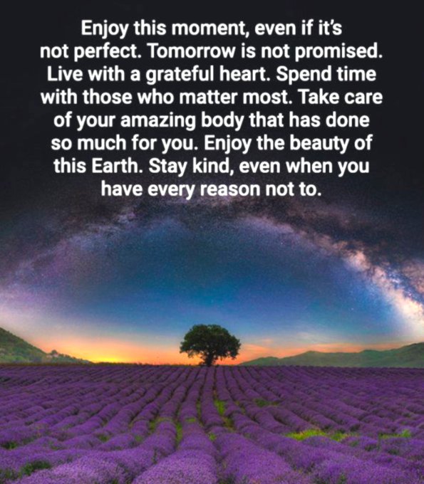 An inspirational quote graphic over a lavender field at sunset with a lone tree and Milky Way galaxy in the sky, reading: 'Enjoy this moment, even if it's not perfect. Tomorrow is not promised. Live with a grateful heart. Spend time with those who matter most. Take care of your amazing body that has done so much for you. Enjoy the beauty of this Earth. Stay kind, even when you have every reason not to.'