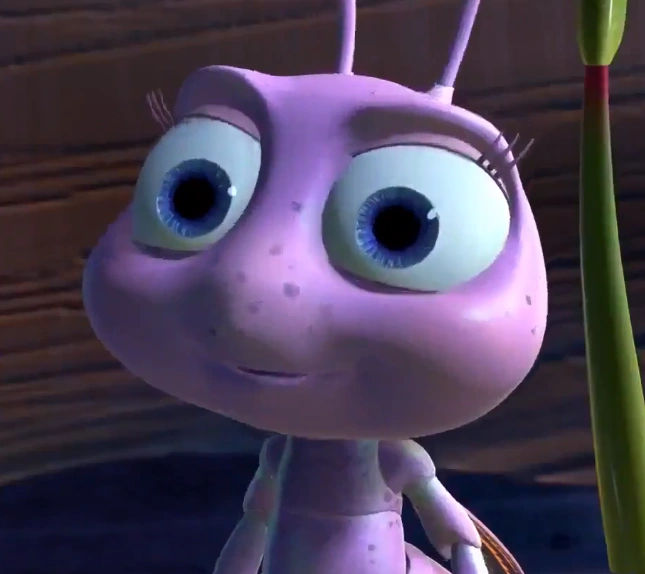 A close-up 3D animated character of a purple ant with large expressive blue eyes, appearing to be from a Pixar-style movie.