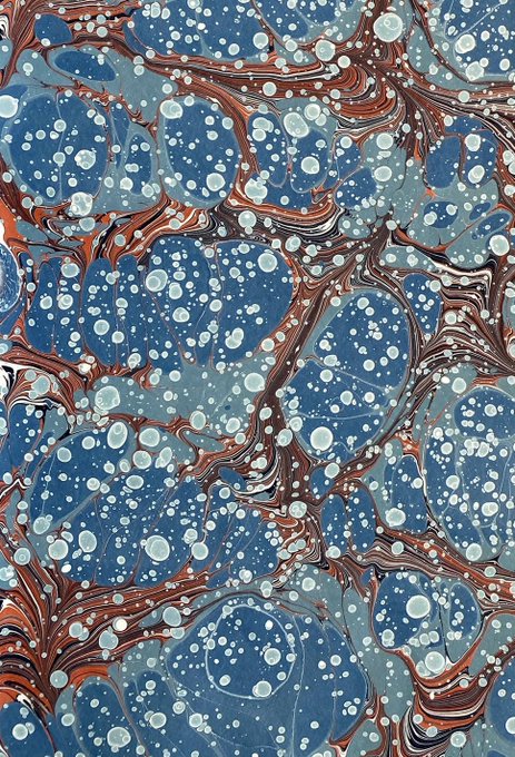 The image features a painting with a marbled effect, which has been printed onto paper. The artwork displays a variety of colors and patterns, creating an interesting visual experience for viewers. The background of the painting appears to be brown or gray, providing a contrast that highlights the vibrant colors of the marbling art. The post includes text such as "Gn Sweet dreams Have a nice weekend! See you tomorrow!" and "NFTs #NFTCommunity #NFTart #tezoscommunity #tezosart #tezos" which are related to the artwork, possibly indicating that it is being sold or shared online.