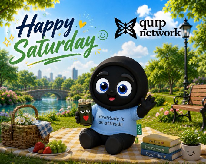 A cheerful cartoon character wearing a 'Gratitude is an attitude' shirt sits on a picnic blanket in a park setting, with text reading 'Happy Saturday' and 'qurp network' displayed above.