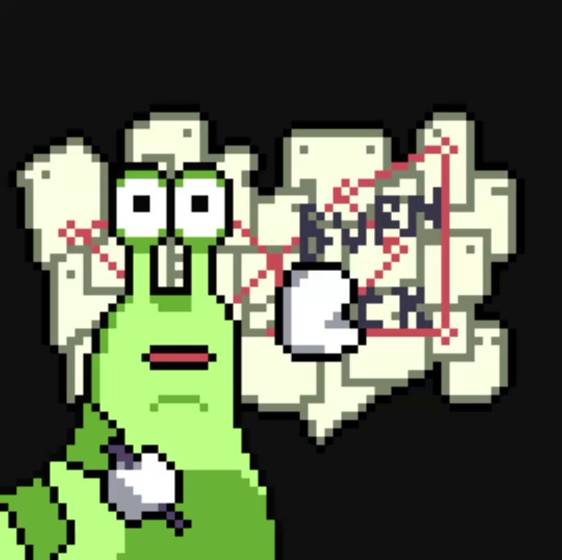 The image features a green cartoon character with big eyes, giving it a face-like appearance. It appears to be holding a white object or button in its hand. The background of the image consists of small squares or blocks that are black in color. There is also text present in the image, which reads "We have all been here before (lock in)", and it seems to be written in red.