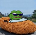 A Pepe the Frog meme character wearing sunglasses holds a large fried chicken drumstick outdoors.
