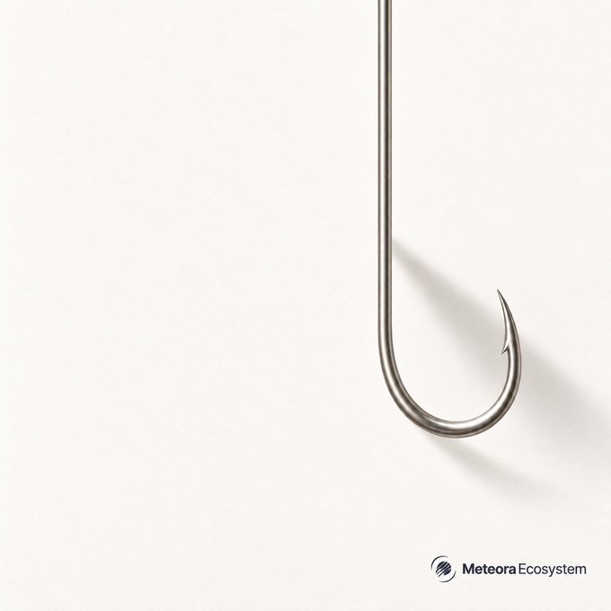 Minimalist advertisement showing a large silver fishing hook hanging against a white background with 'Meteora Ecosystem' logo in the bottom right corner.