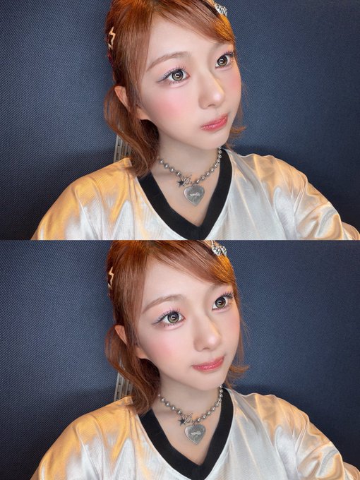 Two stacked selfies of a young woman with reddish-brown hair, wearing a white and gold top and a necklace with a heart pendant, posing against a blue background.