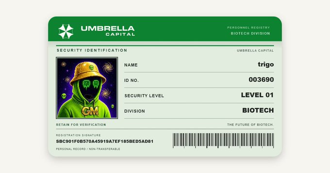 A green Umbrella Capital security identification card for a person named 'trigo' with ID No. 003690, assigned Security Level 01 in the Biotech Division, featuring a cartoon character with a green hoodie and cap.