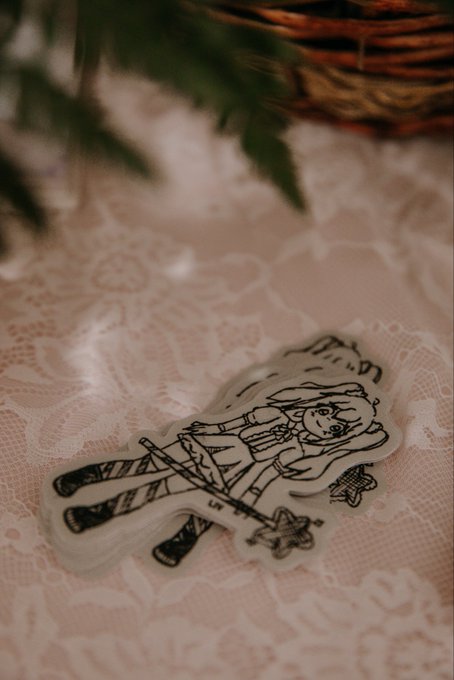 The image features a black and white sticker of a girl with a wand, placed on top of a lace doily. The sticker has a small logo at its bottom right corner, which reads "History in the making, the silhouette in the SpaceX IPO film was the sign we were waiting for, Asteroid Shiba is the official mascot and donating creator fees to Liv'S Foundation". This sticker seems to be a token or a charity token that supports a cause. The image also includes some text about the post, which reads "History in the making, the silhouette in the SpaceX IPO film was the sign we were waiting for, Asteroid Shiba is the official mascot and donating creator fees to Liv'S Foundation".