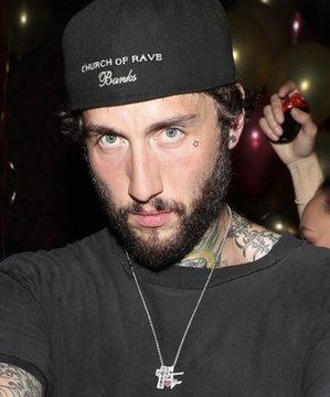 A man wearing a black "Church of Rave" cap and a necklace poses for a close-up photo at what appears to be a party, with balloons visible in the background. The image likely features FaZe Banks, the content creator referenced in the accompanying post about his alt account achievements on FOMO.