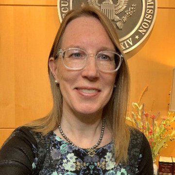 Hester Peirce, a Commissioner of the U.S. Securities and Exchange Commission (SEC), stands in front of the official SEC seal while commenting on her opposition to accredited investor gating restrictions. The post references her stance as the SEC considers easing these investment qualification rules.