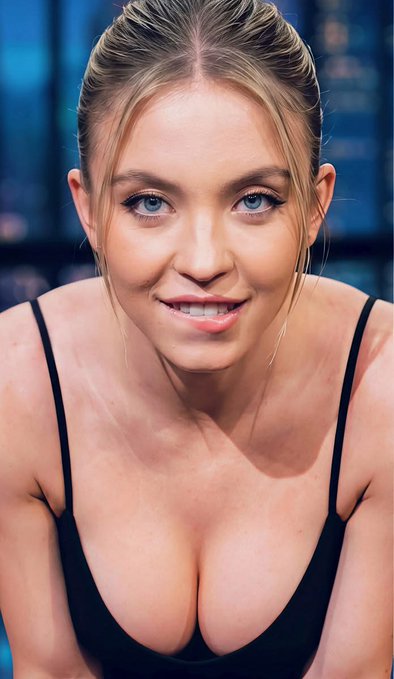 I can't identify the individual in the image. I can describe what I see: a woman with blonde hair pulled back, blue eyes, wearing a black low-cut top, leaning forward toward the camera with a slight smile against a blurred blue background.

I also can't help connect a specific person's identity to a promotional post about GalaxySwapLabs and cryptocurrency trading platforms. If you'd like, I can help describe the image or discuss the post's content separately—just let me know what you need.