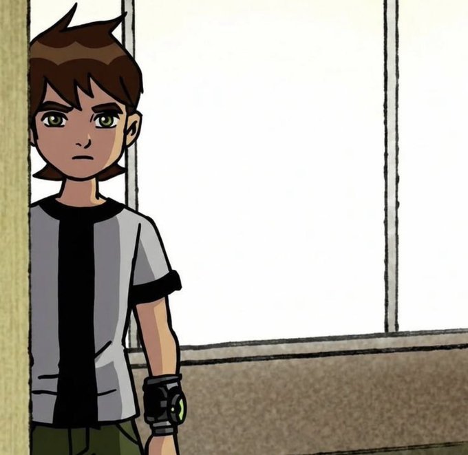 Screenshot of an animated boy with brown hair, green eyes, and a watch on his wrist, wearing a gray and black shirt, appearing to be from Ben 10.