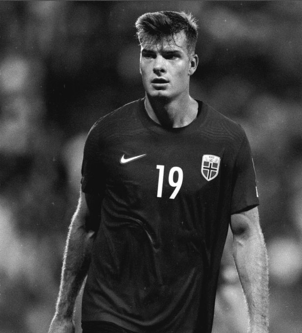 A young footballer wearing a Norway national team jersey with the number 19 looks pensive in this black-and-white image. The "Judas Iscariot" caption suggests the player—resembling footballer Kristoffer Ajer—is being branded as a traitor, evoking the biblical betrayer, likely for switching national allegiance or a controversial transfer.