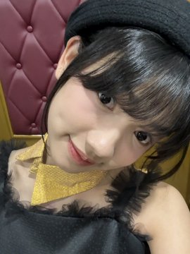A young woman wearing a black beret with a gold bow tie smiles softly at the camera in a close-up selfie, posed against a tufted maroon background. The cozy, stylish shot complements the "tft bd TWT!!" caption, giving off a cute, celebratory vibe perfect for wishing someone a happy birthday.