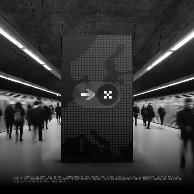 A black-and-white image of commuters walking through a subway station, centered on a large digital billboard displaying the OKX logo and a "Switch to OKX" message. The fine print notes OKX is licensed by the MFSA as a CASP, reinforcing the post's emphasis on OKX being a regulated European crypto exchange offering an 8% deposit bonus.