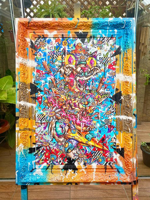 A vibrant, colorful abstract painting in an ornate gold frame sits on an easel outdoors, featuring a chaotic mix of turquoise, pink, yellow, and red with geometric shapes and figures.