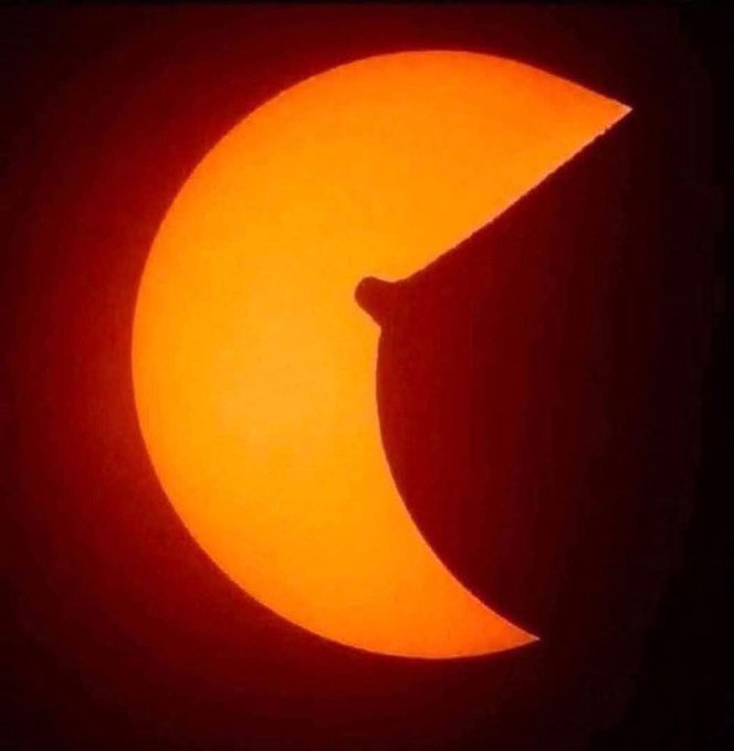 This image shows a partial solar eclipse, featuring the crescent-shaped sun as the moon passes in front of it. The image directly answers the question in the post asking, "Did you get any eclipse pics?"
