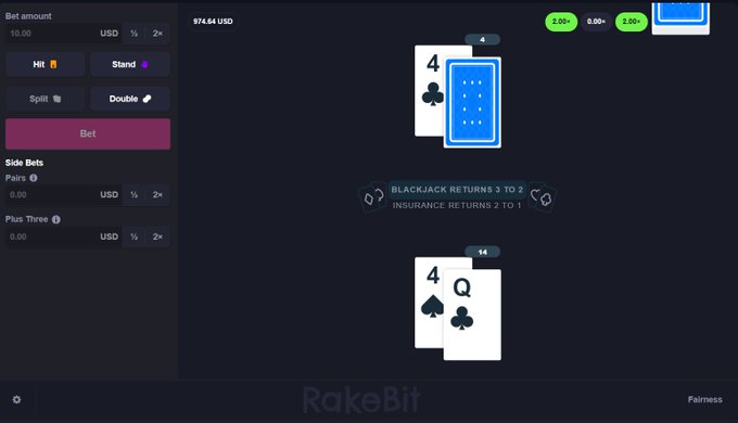 A RakeBit blackjack interface displays a player's hand of 4 of spades and Queen of clubs (totaling 14), facing the dealer's 4 of clubs with a face-down card, showing a balance of 974.64 USD.