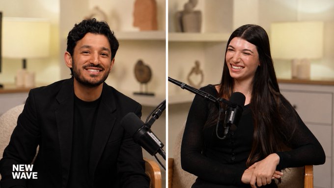 Two podcast guests smile brightly into Shure microphones during a recording session, with "NEW WAVE" branding visible in the corner—likely promoting an upcoming Token2049 Singapore event appearance where the host is seeking more creator and builder guests to feature.