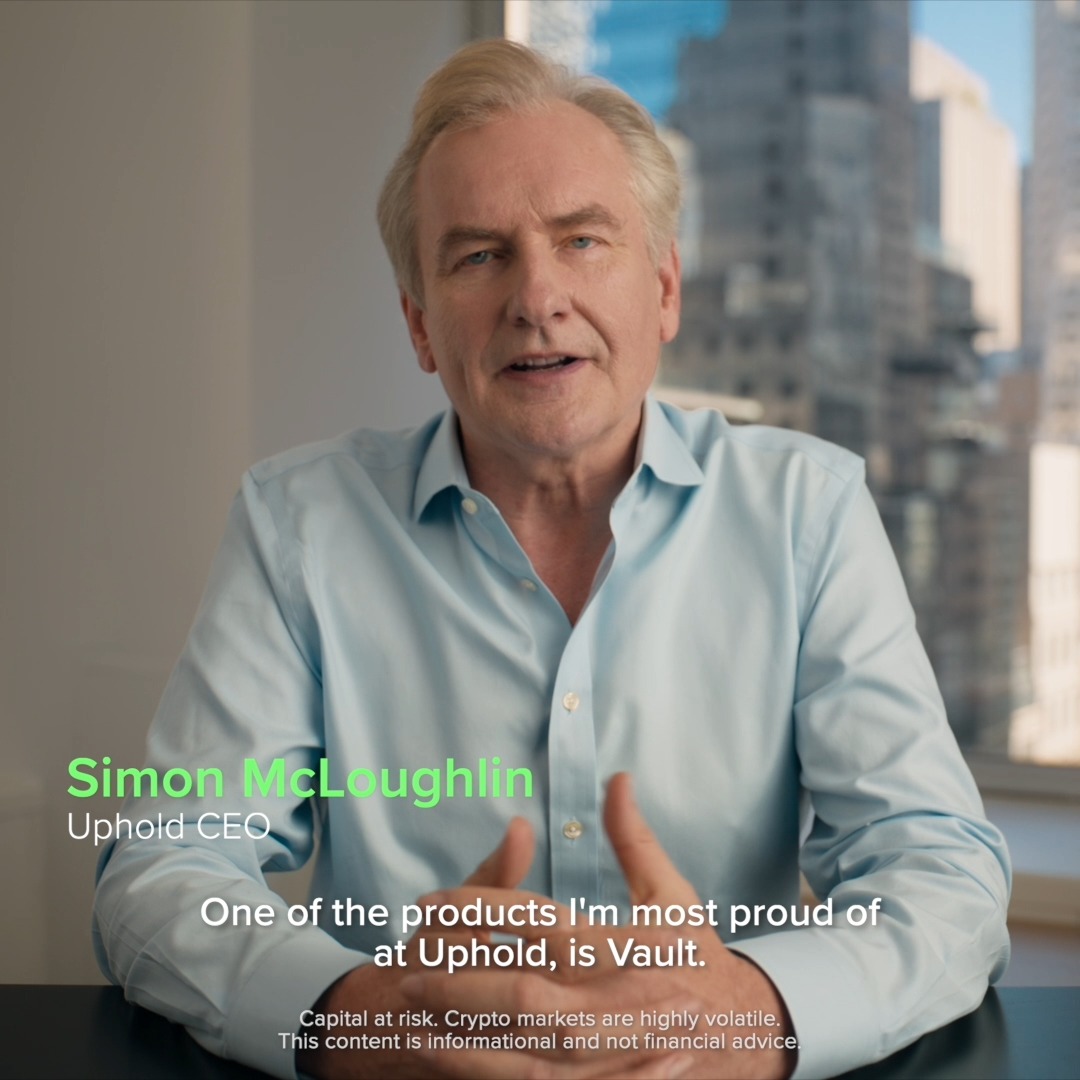 Simon McLoughlin, CEO of Uphold, speaks in an office setting with a city skyline visible through the window behind him, introducing Vault with the caption "One of the products I'm most proud of at Uphold, is Vault." The image supports the post's announcement of Vault Inheritance, a new feature allowing XRP, HBAR, and BTC holders to automatically pass on their crypto assets, with a disclaimer noting that capital is at risk and crypto markets are highly volatile.