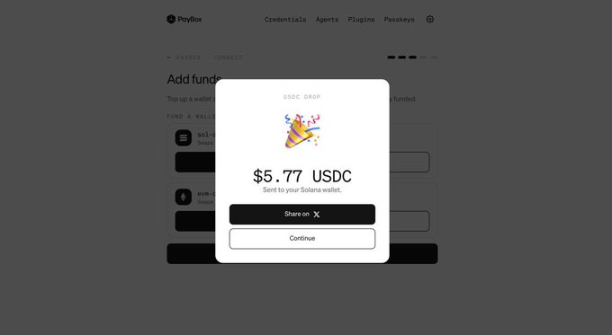 A screenshot of a PayBox interface showing a "USDC DROP" popup featuring a party popper emoji and $5.77 USDC to be sent to a Solana wallet, with options to "Share on X" or "Continue." The image illustrates the supposed "biggest smart airdrop of 2026" mentioned in the post, likely an attempt to trick users into engaging with a crypto promotion tied to a malfunctioning AI system.