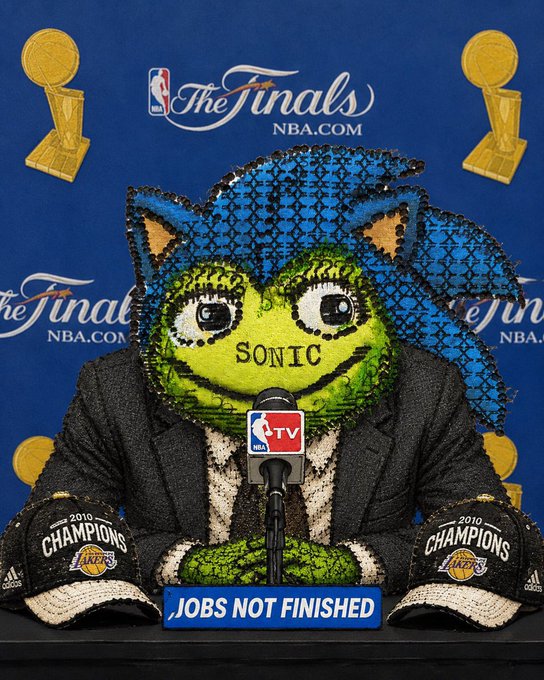 A satirical image showing a Sonic the Hedgehog character at an NBA Finals press conference wearing a suit and 2010 Lakers championship caps, with a 'JOBS NOT FINISHED' sign on the podium.