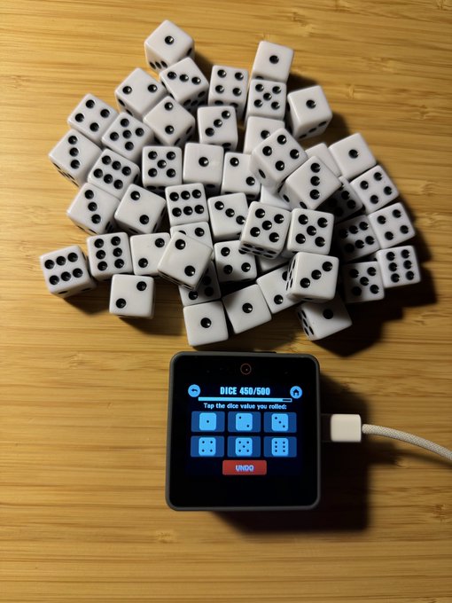 A pile of white dice sits on a wooden surface next to a hardware device displaying "DICE 450/500 - Tap the dice value you rolled" with an UNDO button, visually playing on the concept of "dice rolling" to represent the user's decision to take full control of their crypto custody by abandoning hardware wallets like Tangem in favor of self-managed infrastructure where they can verify every line of code.