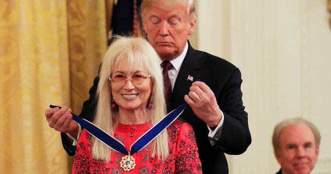 The caption for this image could be: "U.S. President Donald Trump presents an award to a smiling recipient during a formal ceremony, reflecting a moment of honor and recognition." The text in the accompanying post about the CLARITY Act is not directly related to this image, as the event depicted is a medal ceremony and not a legislative passing. The connection between the two could be the celebration of an achievement or milestone that correlates with the enactment of the CLARITY Act, although this is speculative without further context.