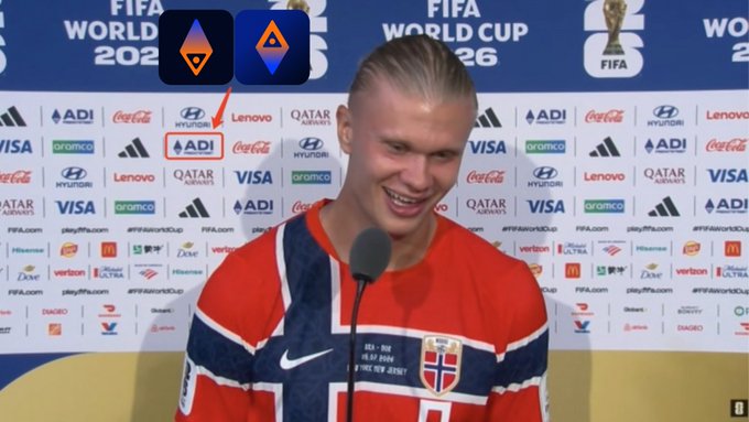 Norwegian footballer Erling Haaland smiling at a FIFA World Cup 2026 press conference, with ADI logo highlighted by a red arrow in the background.