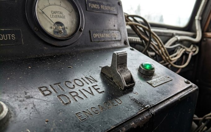 A weathered industrial control panel labeled 'BITCOIN DRIVE' with an 'ENGAGED' switch, a 'CAPITAL LEVERAGE' gauge, and an illuminated green 'ENGAGED' button.