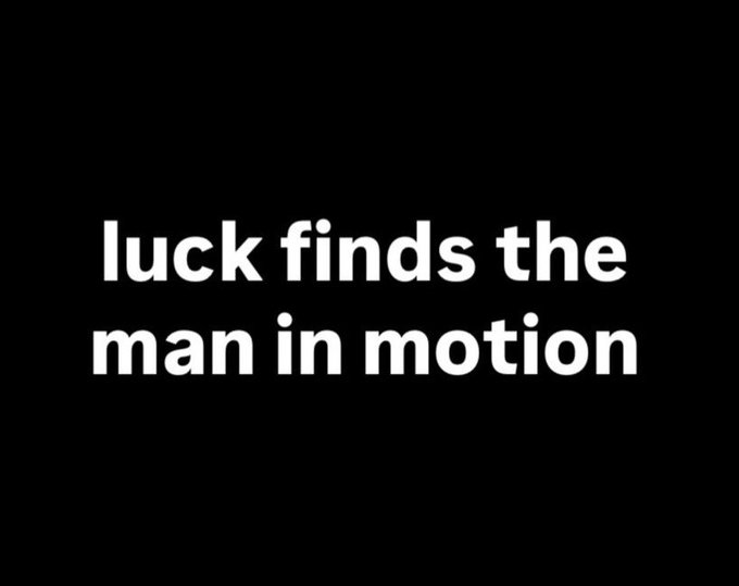 White text on a black background reading 'luck finds the man in motion'.