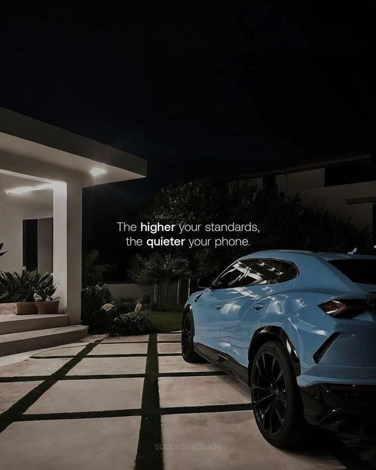 The image features a blue Lamborghini parked outside a house at night. The car's headlights are on, illuminating its sleek design as it sits in front of the house. The text "The higher your standards, the quieter your phone" is written above the car, suggesting that having high expectations for one's phone usage can lead to a more peaceful and focused experience. This message seems to be related to the post about the trading community on Solana, as it emphasizes the importance of aligning with shared sentiment in order to stand out and engage effectively within the platform.