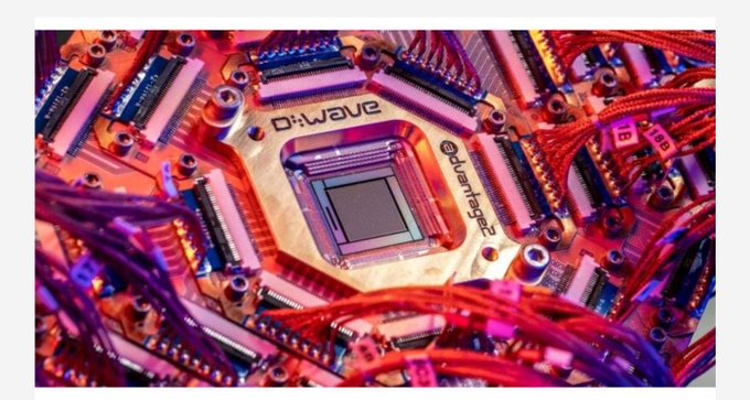 A close-up of a D-Wave quantum computing chip surrounded by intricate red wiring and circuitry, labeled with "D-Wave" and "D:Quantum" text. The image illustrates the advanced quantum hardware technology that the post highlights as part of Quip Network's efforts to educate the public about complex technologies.