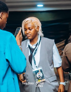 A woman with blonde hair wearing a lanyard with a "Ties Dao" ID badge stands among attendees at the event, as another person beside her holds up a phone. The "Ties Dao Boarding" logo in the corner reinforces the post's celebratory message about the founder's gratitude for the successful gathering.
