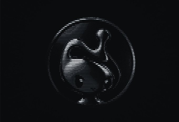 A stylized, pixelated silver icon of a smiling, blob-like creature inside a circle against a black background.