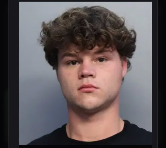 A young man with curly brown hair is pictured in what appears to be a mugshot-style photo against a gray background. The post references a token ticker ($JACK) and a pump address, seemingly joking about the man being "behind bars" in relation to the cryptocurrency's volatility.